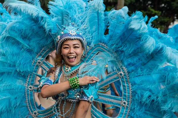 A feathered dancer laughs during an arts festival. The Dream Parade is an annual arts carnival and street parade that takes place in Taipei. The event is the brainchild of real estate developer Gordon Tsai who founded the Dream Community after being inspired by simialr events in other parts of the world.