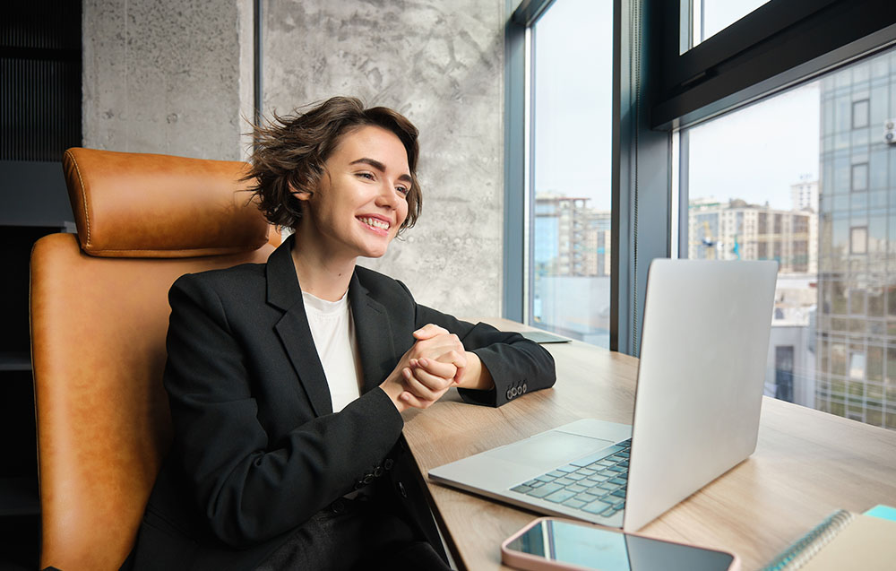 image showing happy women enjoying digital asset managemetn on her laptop