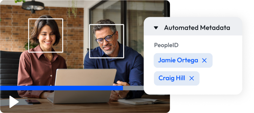 Image of two people working being identified by ai in a video via digital asset management